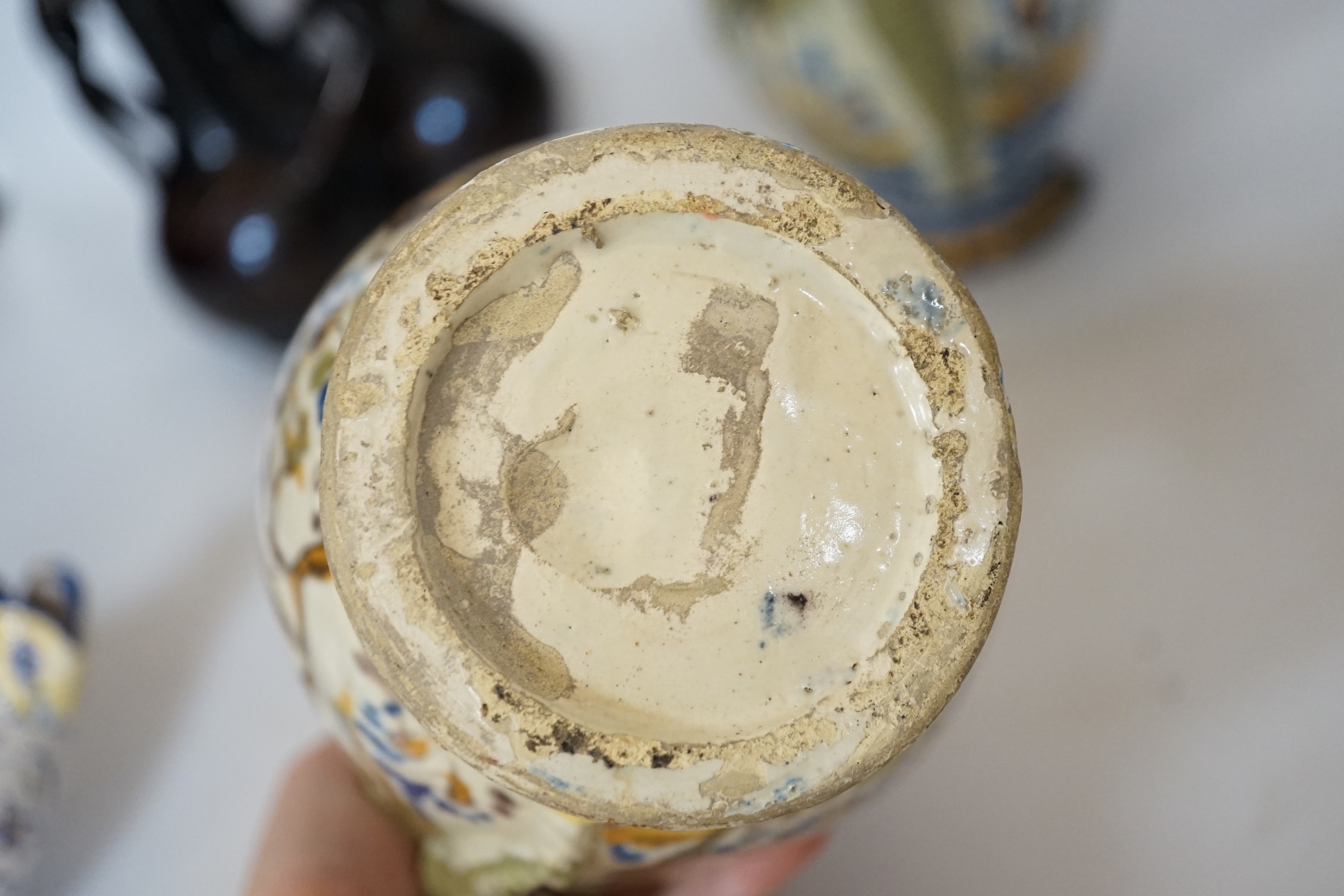 A Slavonic three section brown glazed earthenware puzzle jug and pair of 19th century Portuguese lizard handle maiolica vases and two other similar items, largest 28cm high